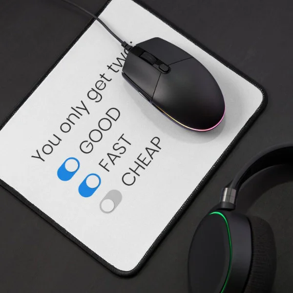 A mouse pad with the phrase "You only get two: good, fast, cheap" in dark letters.